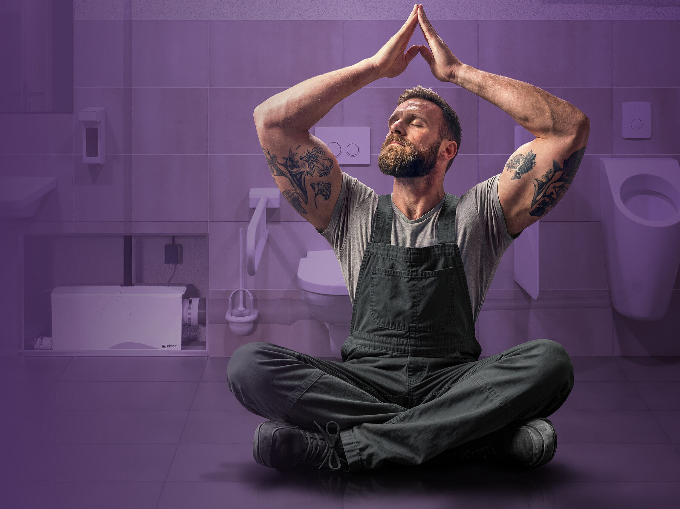 A relaxed tradesman in a commercial toilet, with a double flush system in the background.