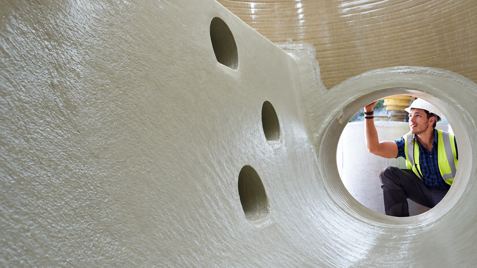 Inside of a GRP tank An employee is inspecting the quality of a bespoke GRP tank.
